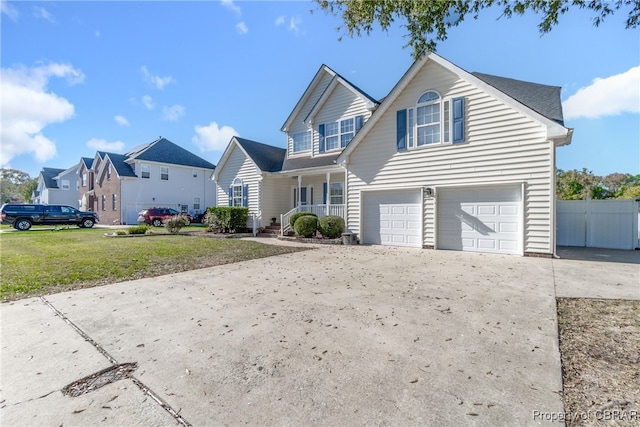 front of property with covered porch, a front lawn, and a garage