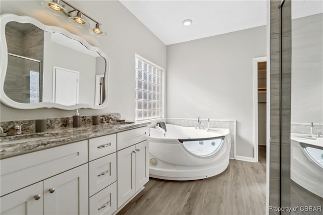 bathroom with vanity, hardwood / wood-style floors, and independent shower and bath