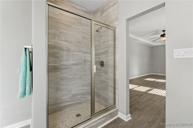 bathroom with ceiling fan, hardwood / wood-style flooring, and an enclosed shower