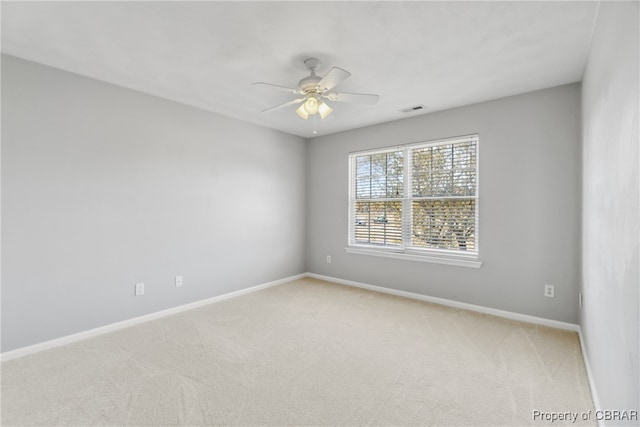 carpeted empty room featuring ceiling fan