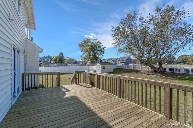 wooden deck featuring a yard and a shed