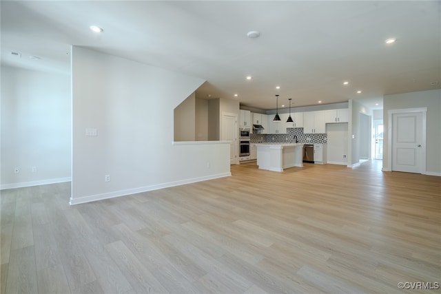 unfurnished living room featuring light hardwood / wood-style flooring