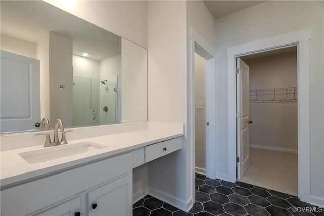 bathroom with vanity, walk in shower, and tile patterned flooring