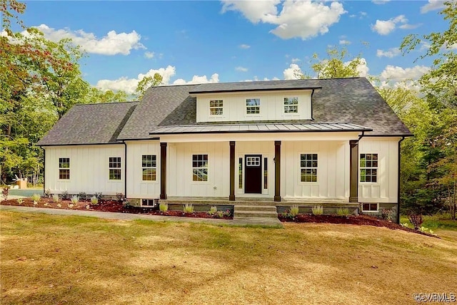 modern farmhouse style home featuring a front yard and a porch