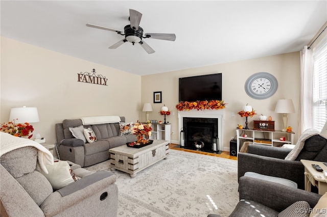 living room with light wood-type flooring and ceiling fan