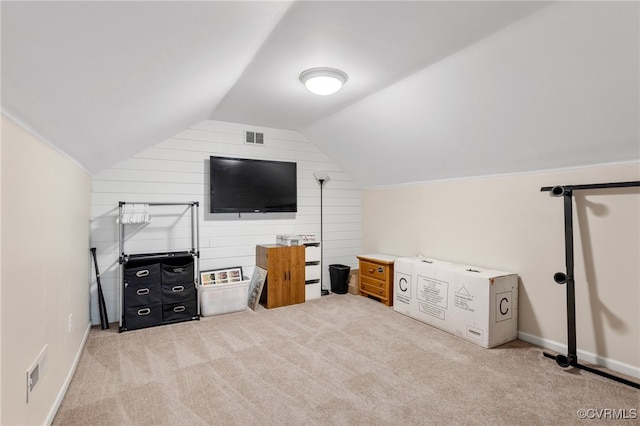 interior space with light carpet and vaulted ceiling