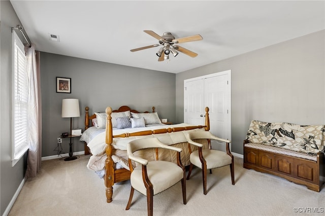 carpeted bedroom featuring multiple windows, a closet, and ceiling fan