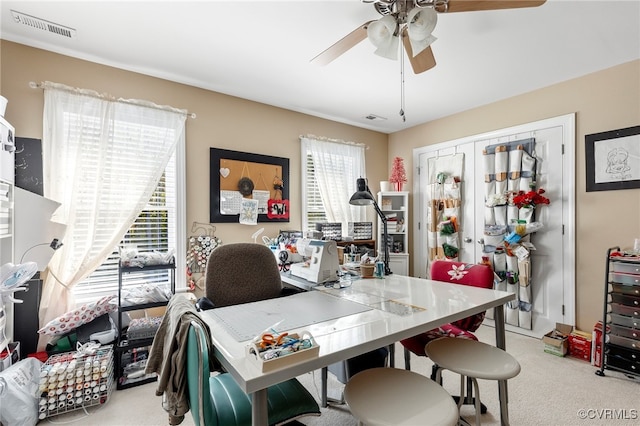 carpeted office with ceiling fan