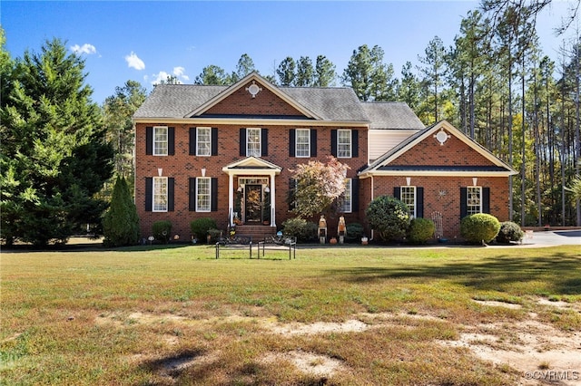 colonial home with a front lawn