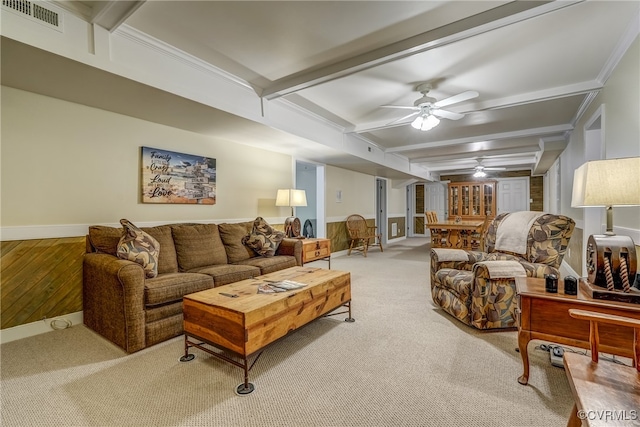 living room with beam ceiling, crown molding, light colored carpet, and ceiling fan