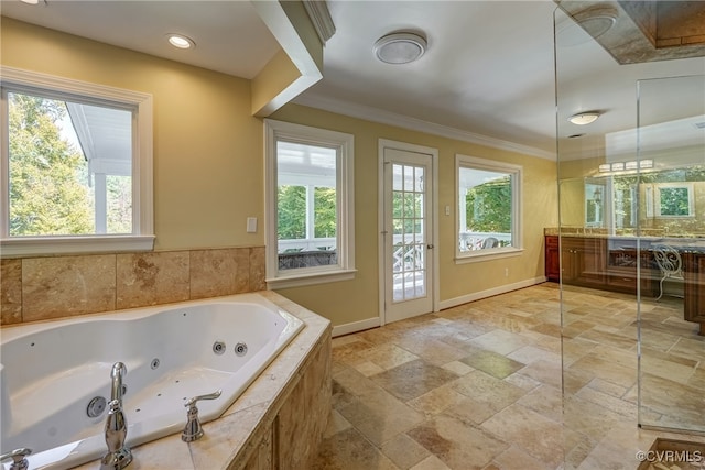 bathroom with vanity, crown molding, tiled tub, and plenty of natural light