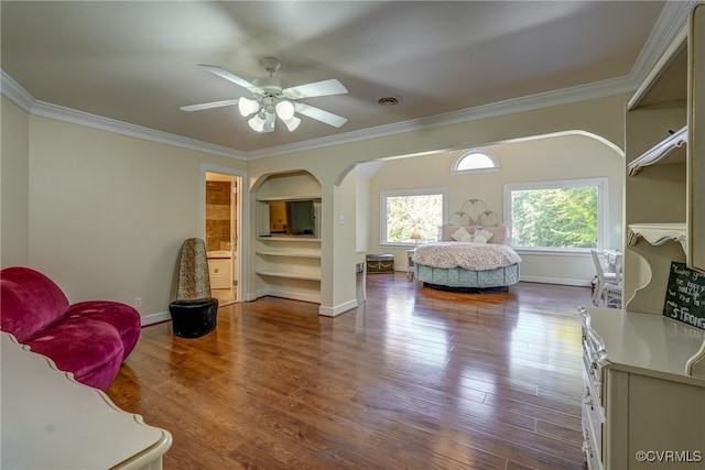 bedroom with hardwood / wood-style floors, crown molding, and ceiling fan