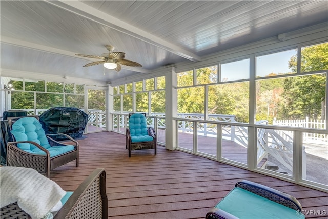 sunroom with beamed ceiling and ceiling fan