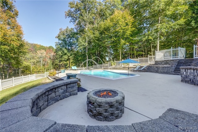 view of pool featuring an outdoor fire pit, a patio area, and pool water feature