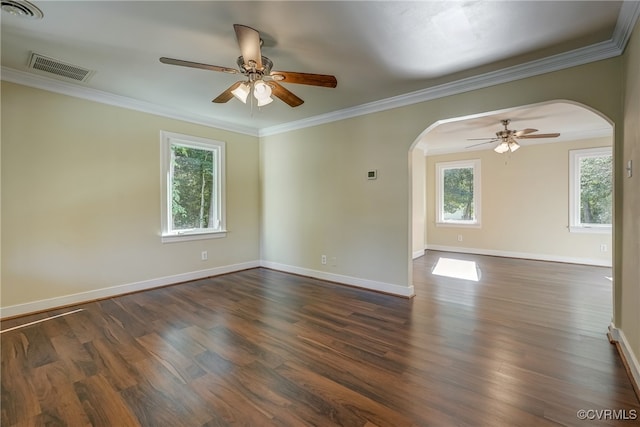 spare room with crown molding, dark hardwood / wood-style floors, and plenty of natural light