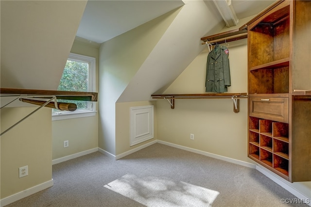 spacious closet featuring light carpet and vaulted ceiling with beams