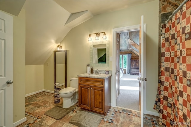 bathroom with vanity, toilet, vaulted ceiling, and a shower with curtain