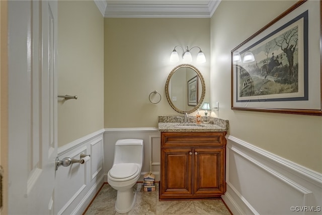 bathroom featuring vanity, ornamental molding, and toilet