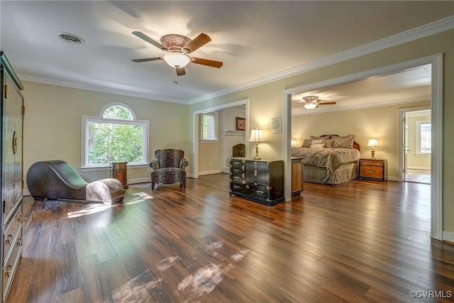 bedroom featuring ornamental molding, dark hardwood / wood-style floors, a fireplace, and ceiling fan