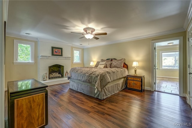 bedroom featuring dark wood-type flooring, multiple windows, and ceiling fan