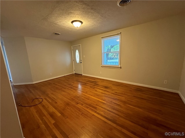 entrance foyer featuring a textured ceiling and hardwood / wood-style floors