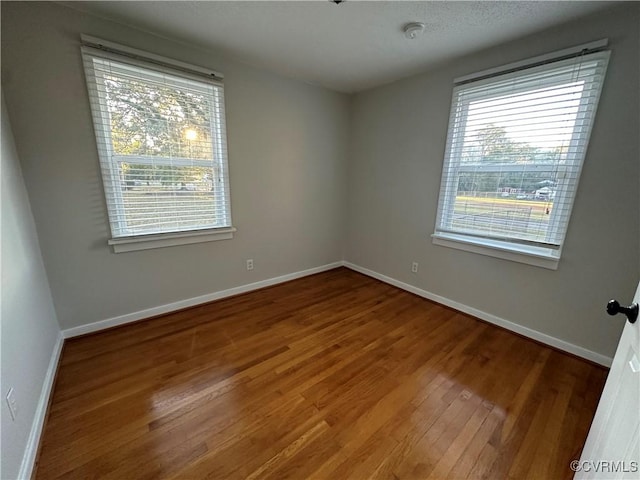 unfurnished room featuring wood-type flooring