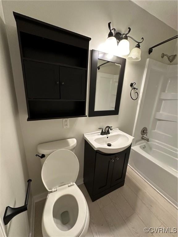 full bathroom with hardwood / wood-style floors,  shower combination, vanity, and toilet