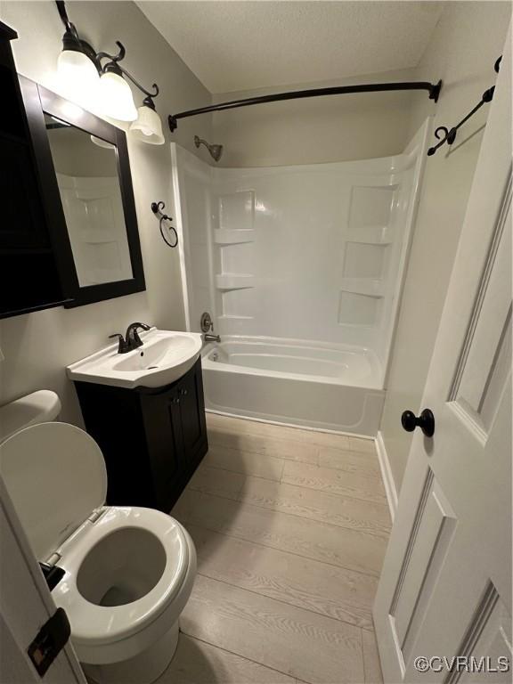 full bathroom featuring toilet, vanity, and shower / bath combination