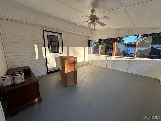 unfurnished sunroom with ceiling fan