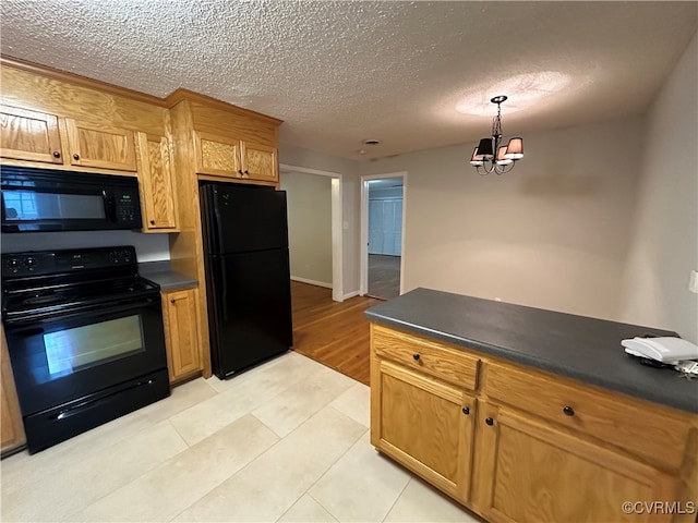 kitchen with a textured ceiling, light tile patterned floors, hanging light fixtures, a chandelier, and black appliances