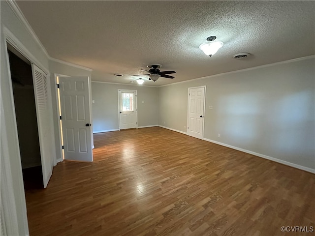 empty room with hardwood / wood-style flooring, a textured ceiling, ceiling fan, and crown molding