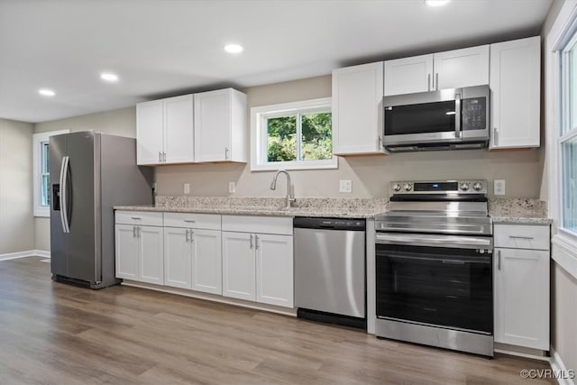 kitchen featuring appliances with stainless steel finishes and white cabinetry