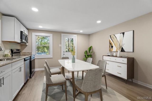 dining room featuring sink and wood-type flooring