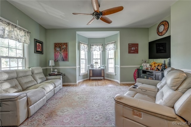 living room with light hardwood / wood-style flooring and ceiling fan