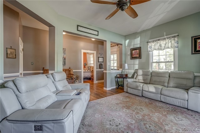 living room featuring light hardwood / wood-style floors and ceiling fan