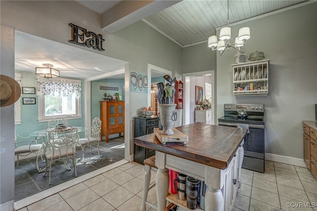 kitchen with butcher block countertops, stainless steel electric range, a notable chandelier, ornamental molding, and light tile patterned floors