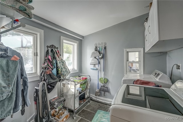 washroom with cabinets and washer and dryer