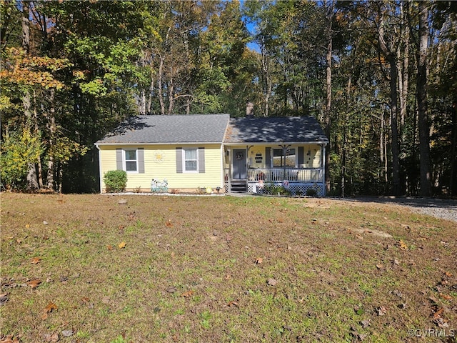 single story home featuring covered porch and a front yard