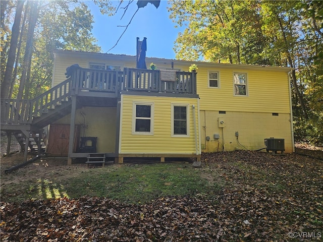 rear view of property with central AC and a wooden deck