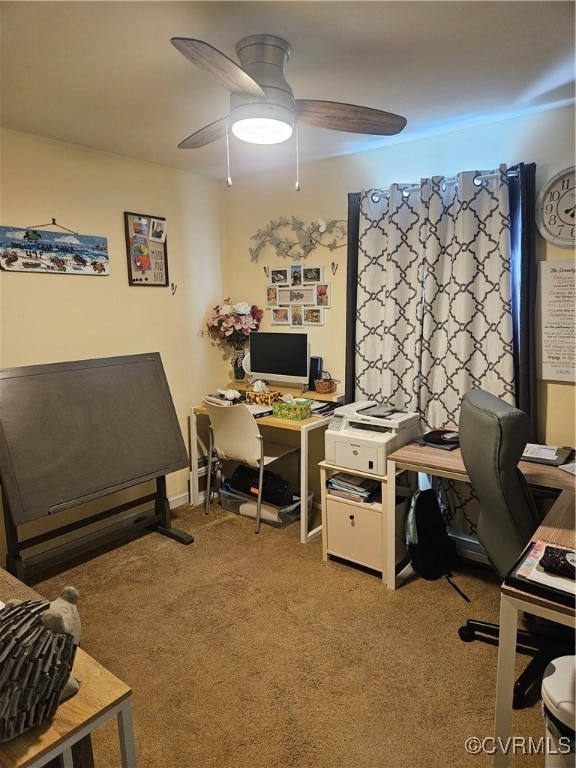 carpeted office featuring ceiling fan