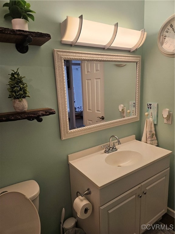 bathroom featuring vanity and toilet