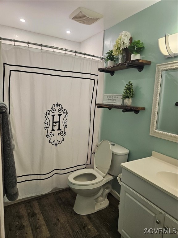 bathroom with vanity, hardwood / wood-style floors, a shower with shower curtain, and toilet