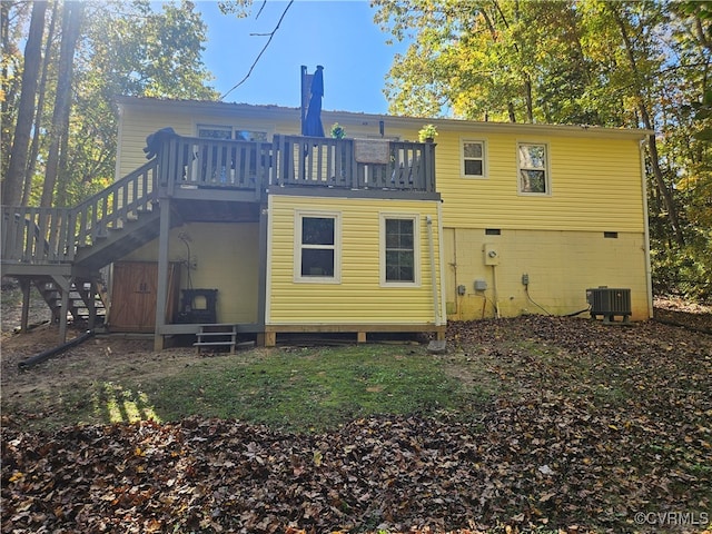 back of property featuring central air condition unit and a wooden deck