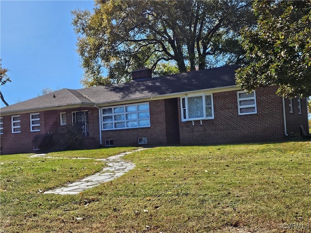 rear view of house featuring a lawn