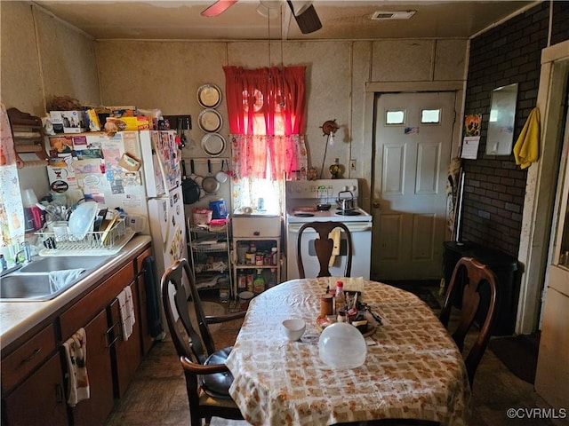 dining room featuring ceiling fan and sink