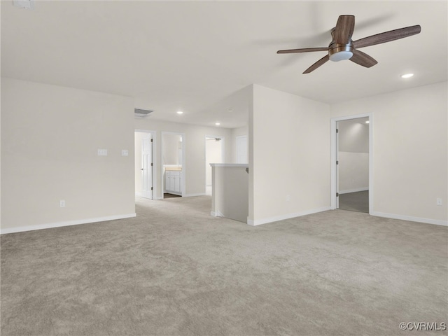 unfurnished room featuring ceiling fan and light carpet