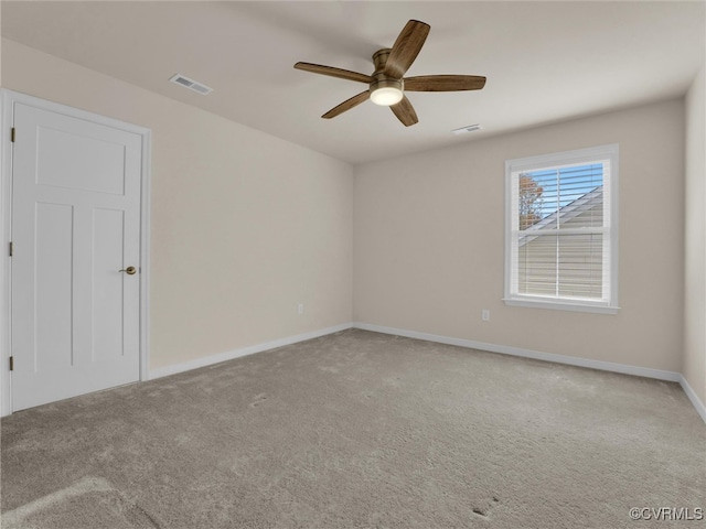 unfurnished room with ceiling fan and light colored carpet