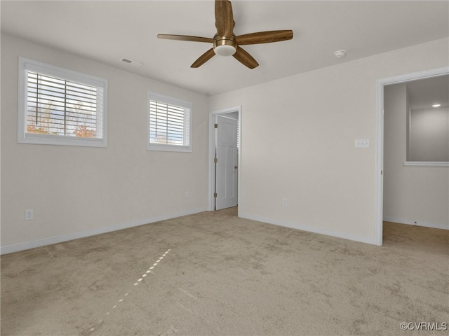 carpeted empty room with ceiling fan