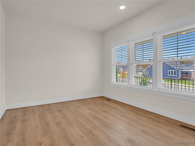 spare room with light hardwood / wood-style flooring