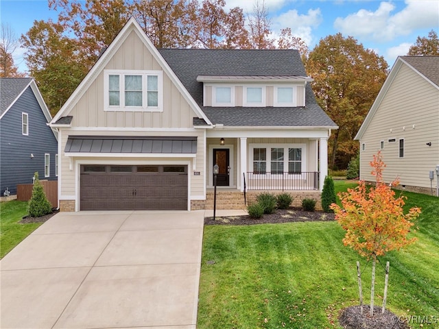 craftsman-style house featuring a front yard, a garage, and covered porch